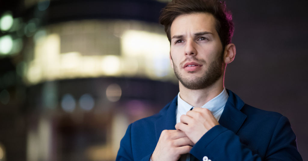 Young man straightens his tie nervously yet confidently, walking into his job interview