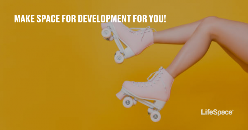 A person kicks their rollerskates over a brightly-colored background